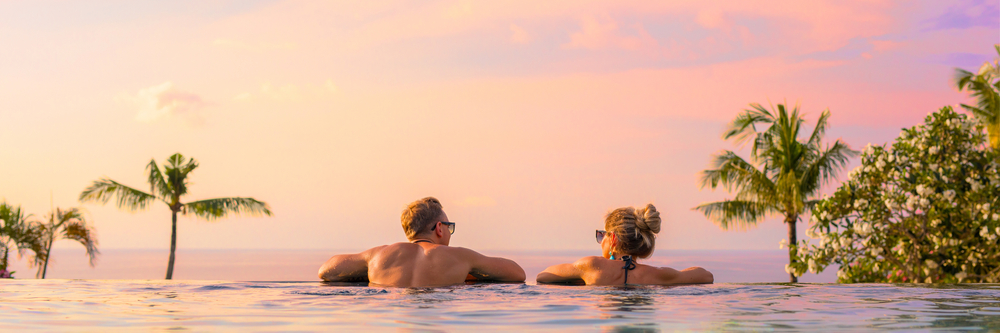 Panoramic,Photo,Of,Couple,In,Pool,Enjoying,Tropical,Vacation,By